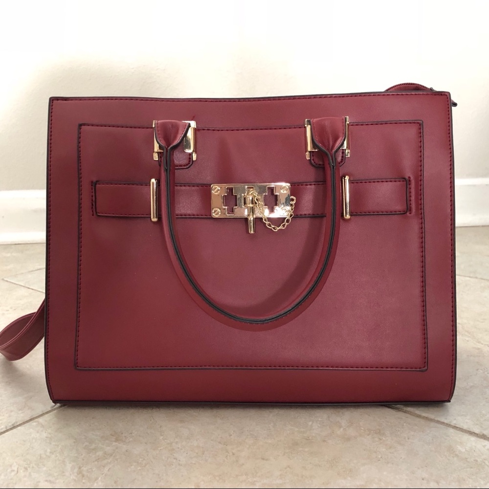 Burgundy satchel/purse accented in gold hard wear.